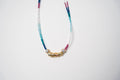 COLLAR CORTO PIEDRITAS UN DIJE DORADO